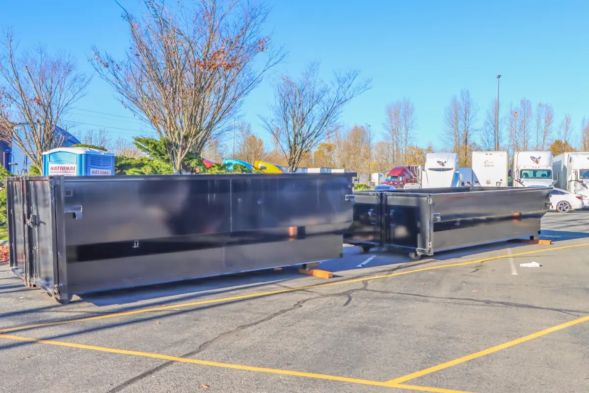 Professional dumpster rental service with roll-off container on residential driveway in Rock Falls